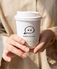 Picture of a woman holding a cup with bubas logo